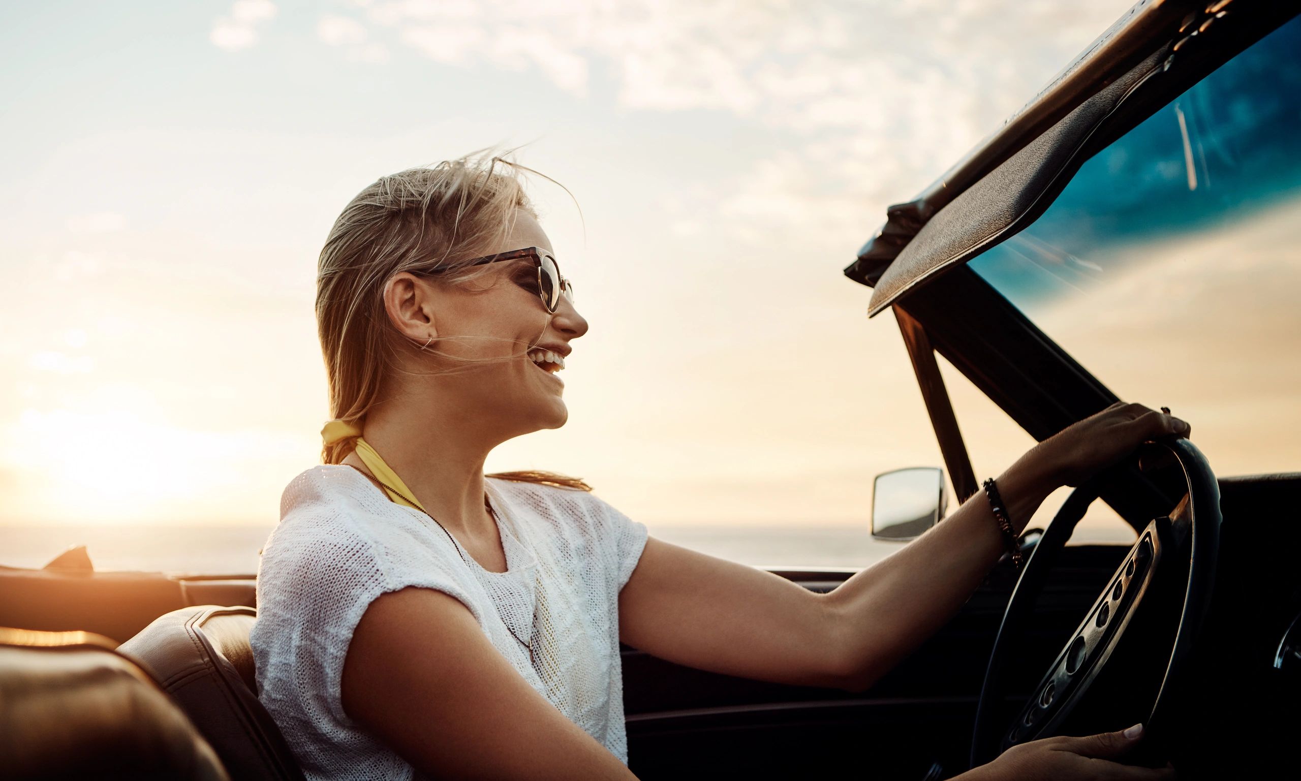 Woman enjoying a road trip at sunset