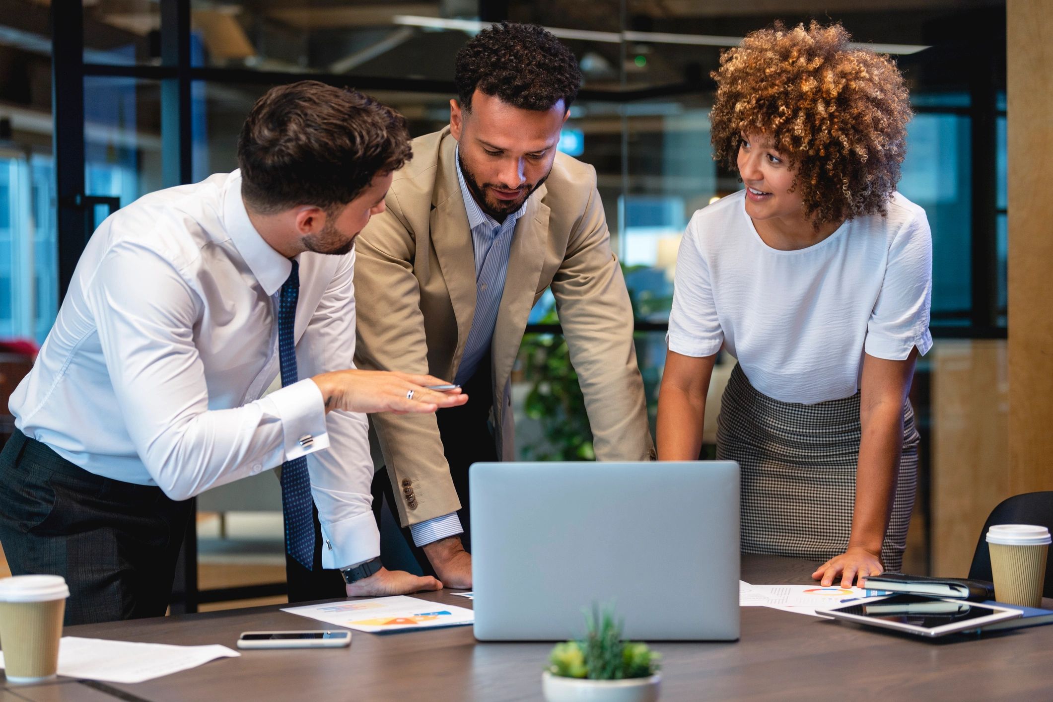 Business team collaborating around a laptop