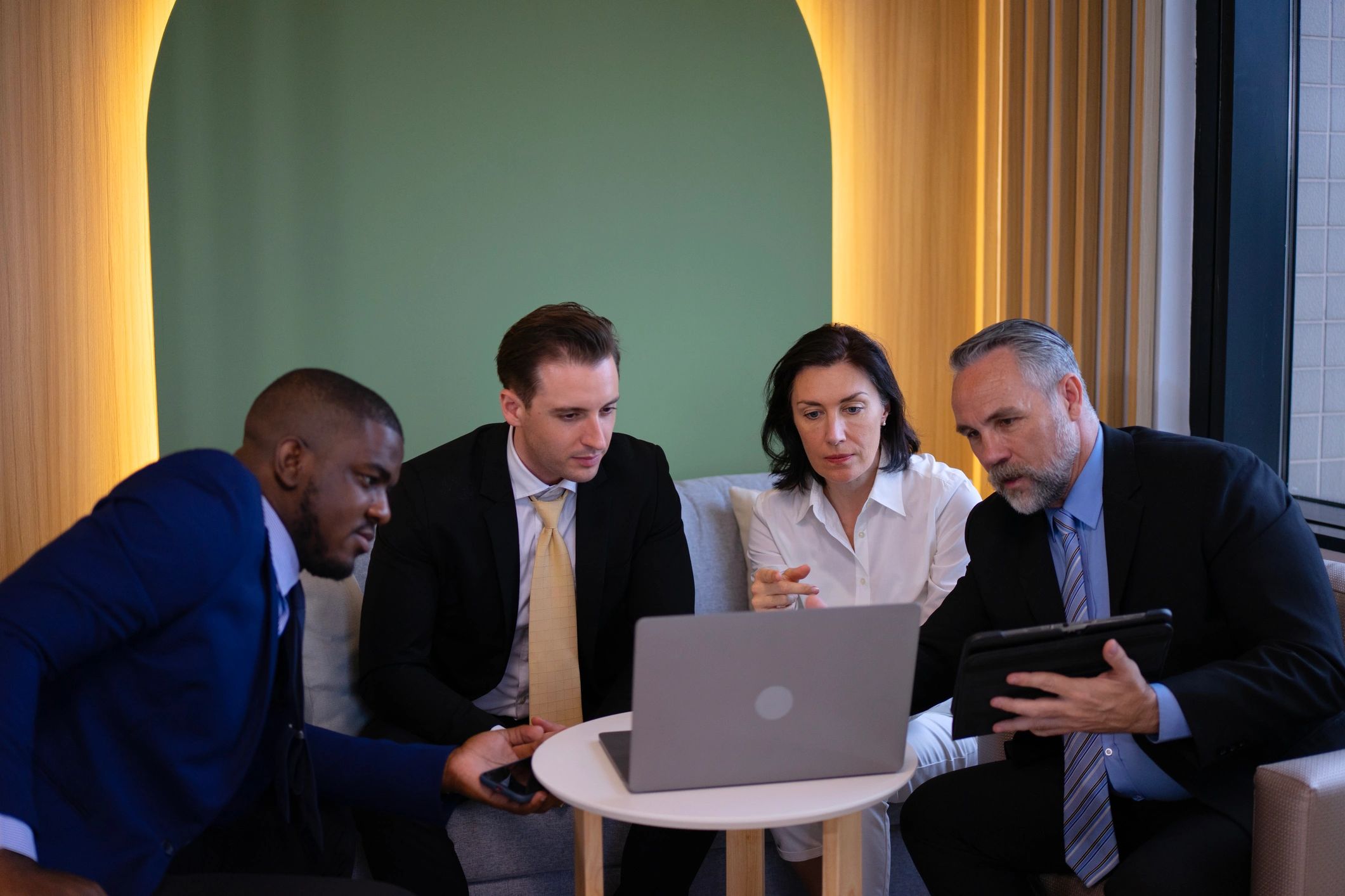 Team collaborating around software dashboards