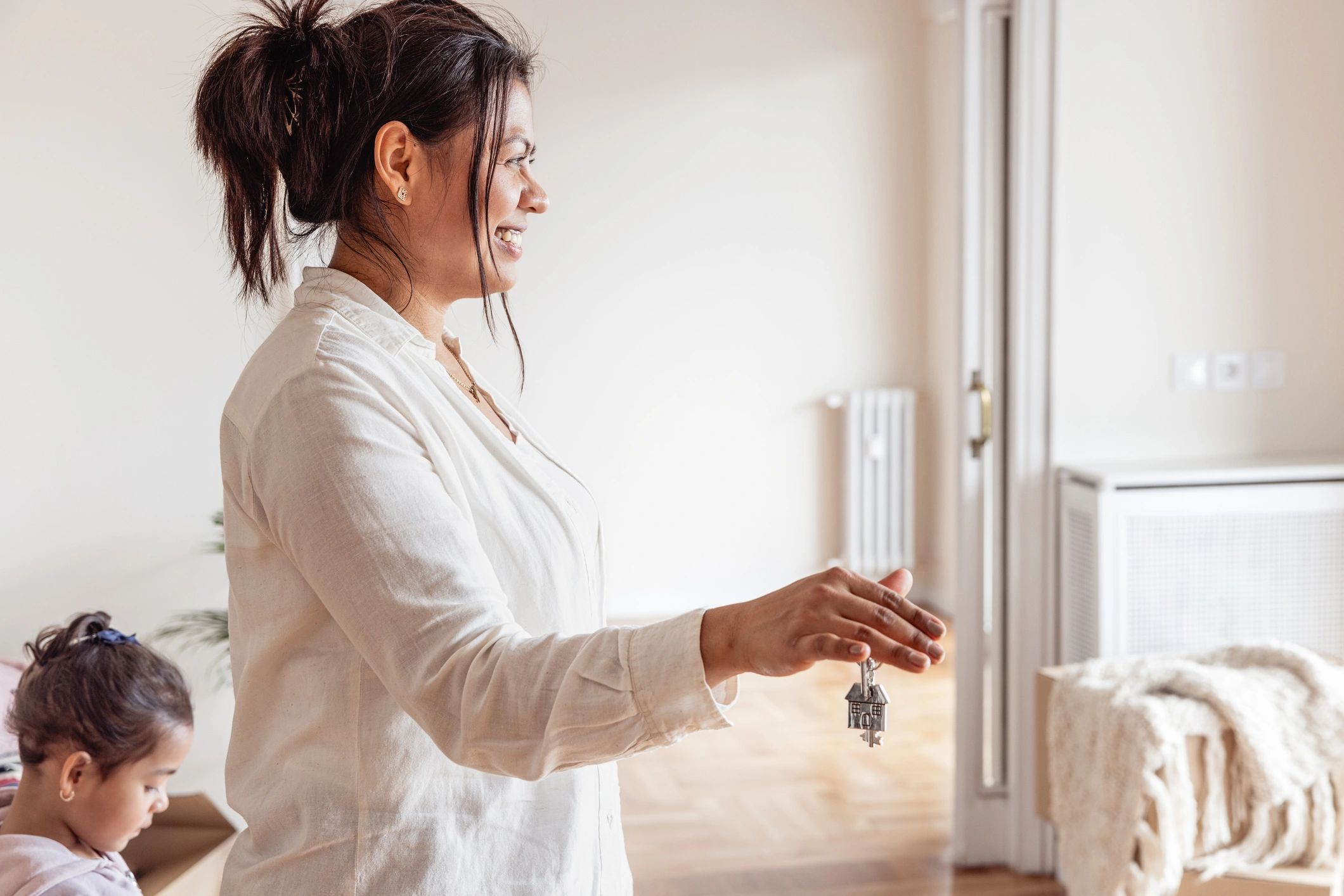 Mother holding keys to her new home