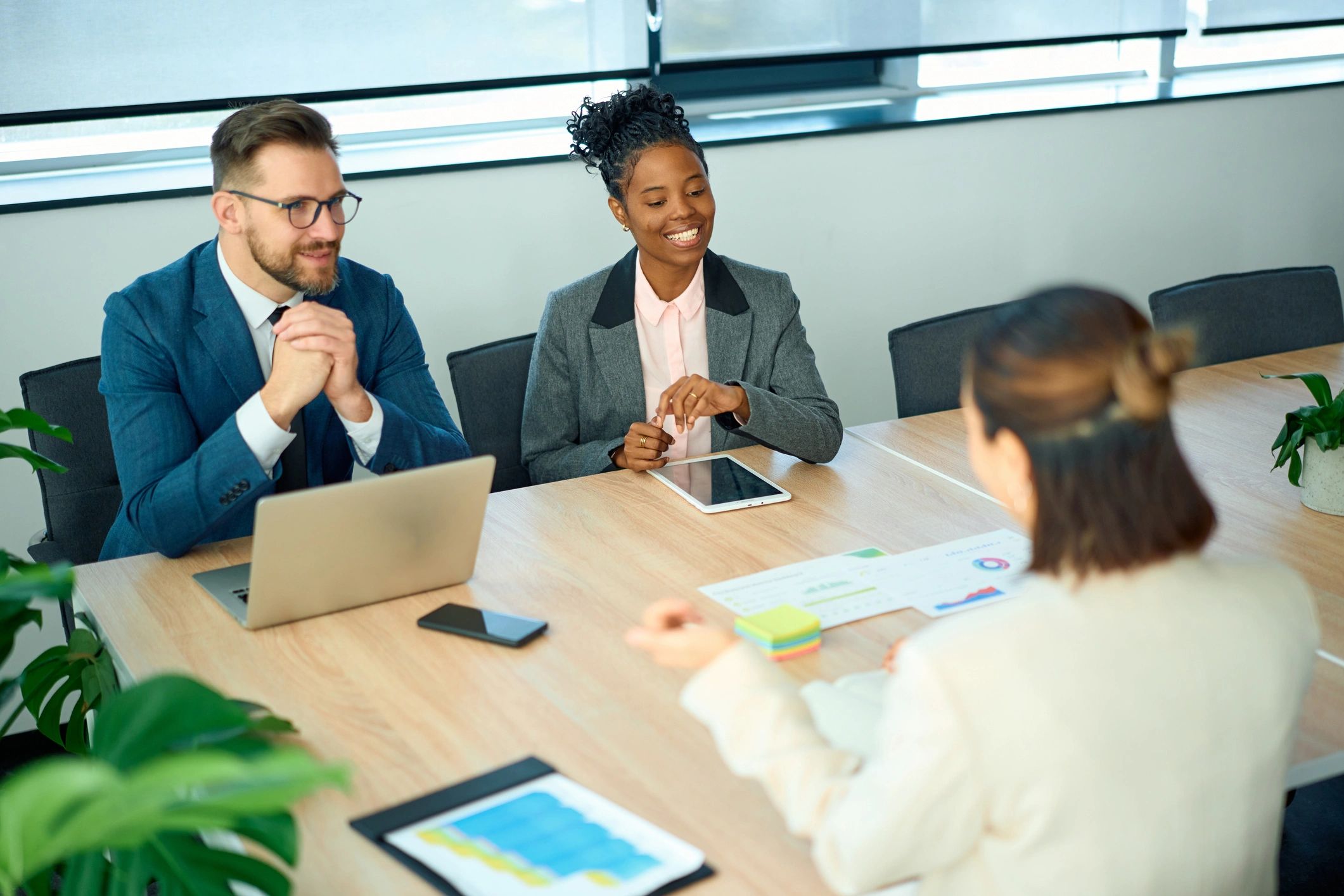 Business professionals collaborating on follow-up planning