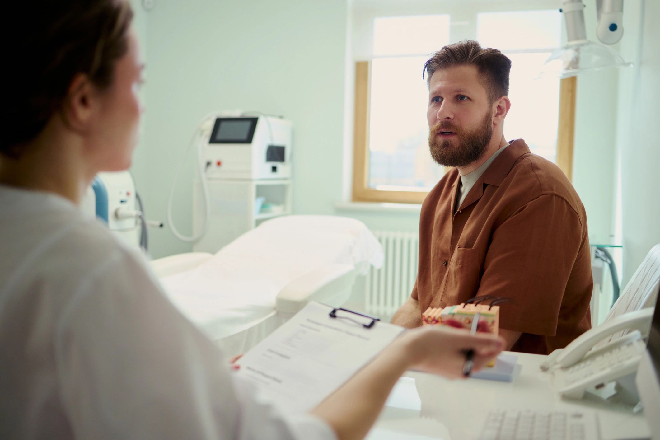 Man consulting a doctor during a clinic appointment